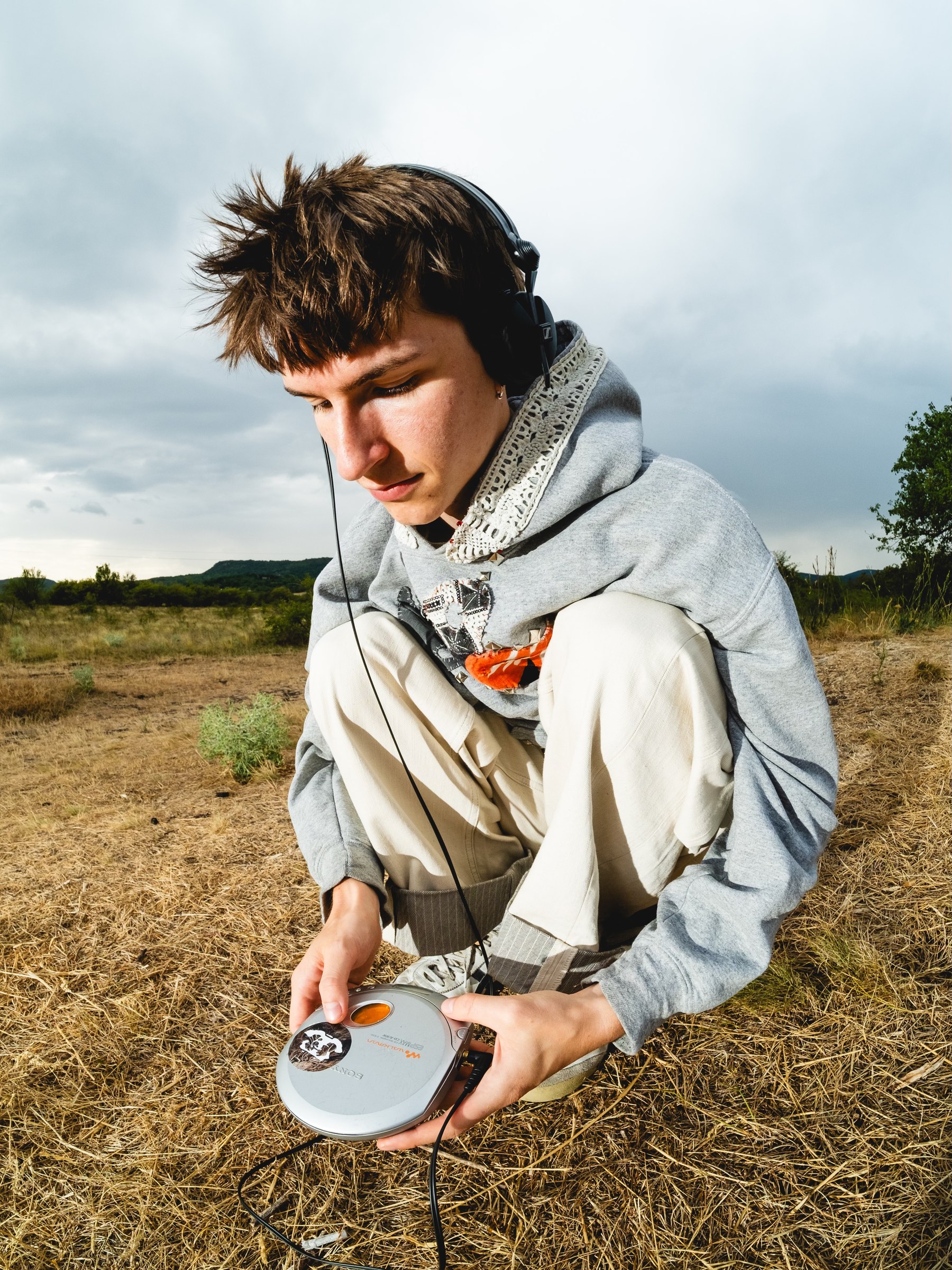 Vava in a field with a portable CD player